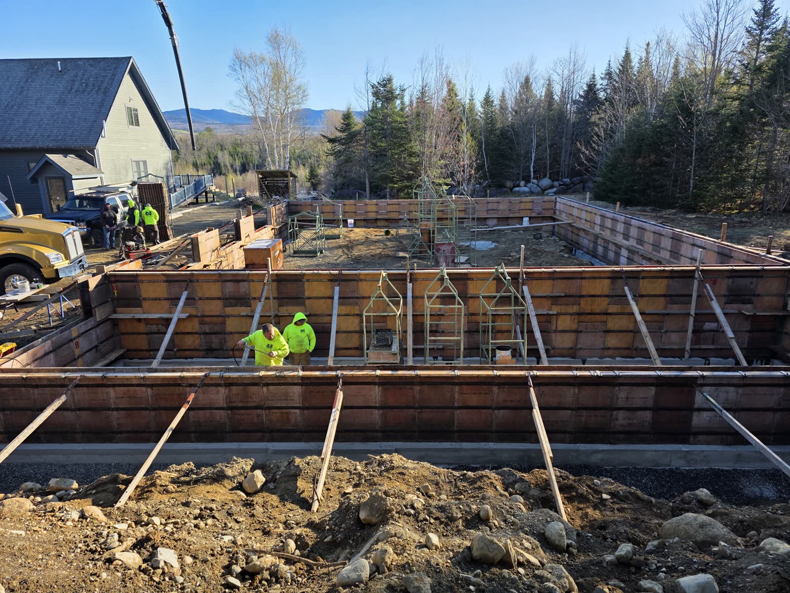 Pouring the foundation walls at a Winter Construction garage build in Western Maine