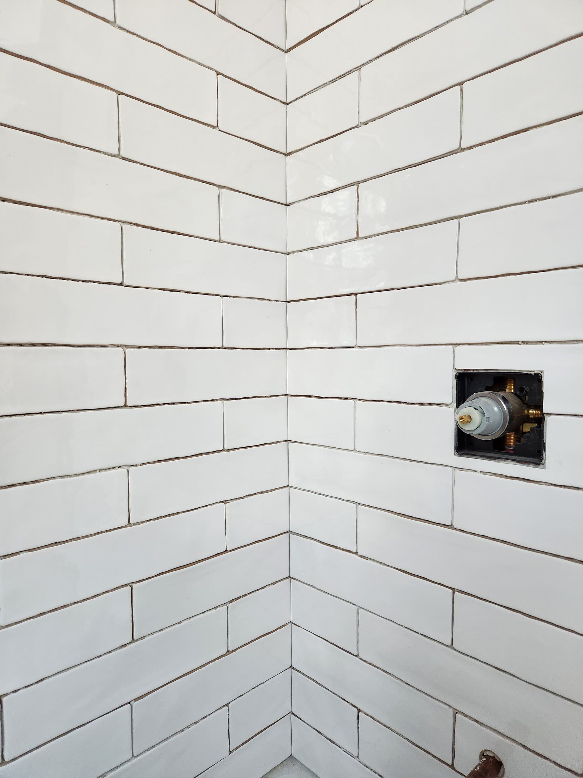 White subway tile surround winter construction bathroom remodel maine