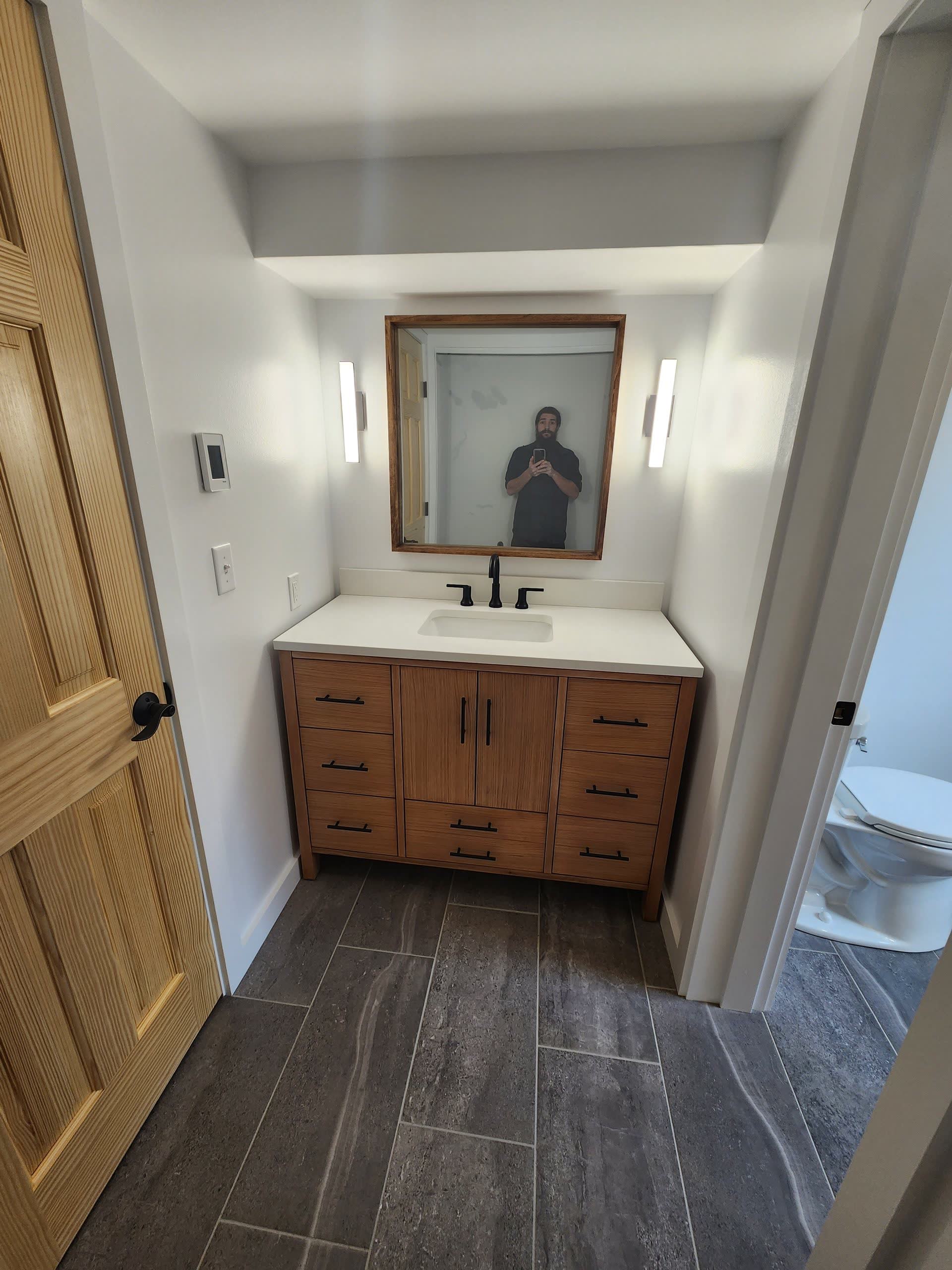 Vanity framed mirror sconces winter construction bathroom remodel maine