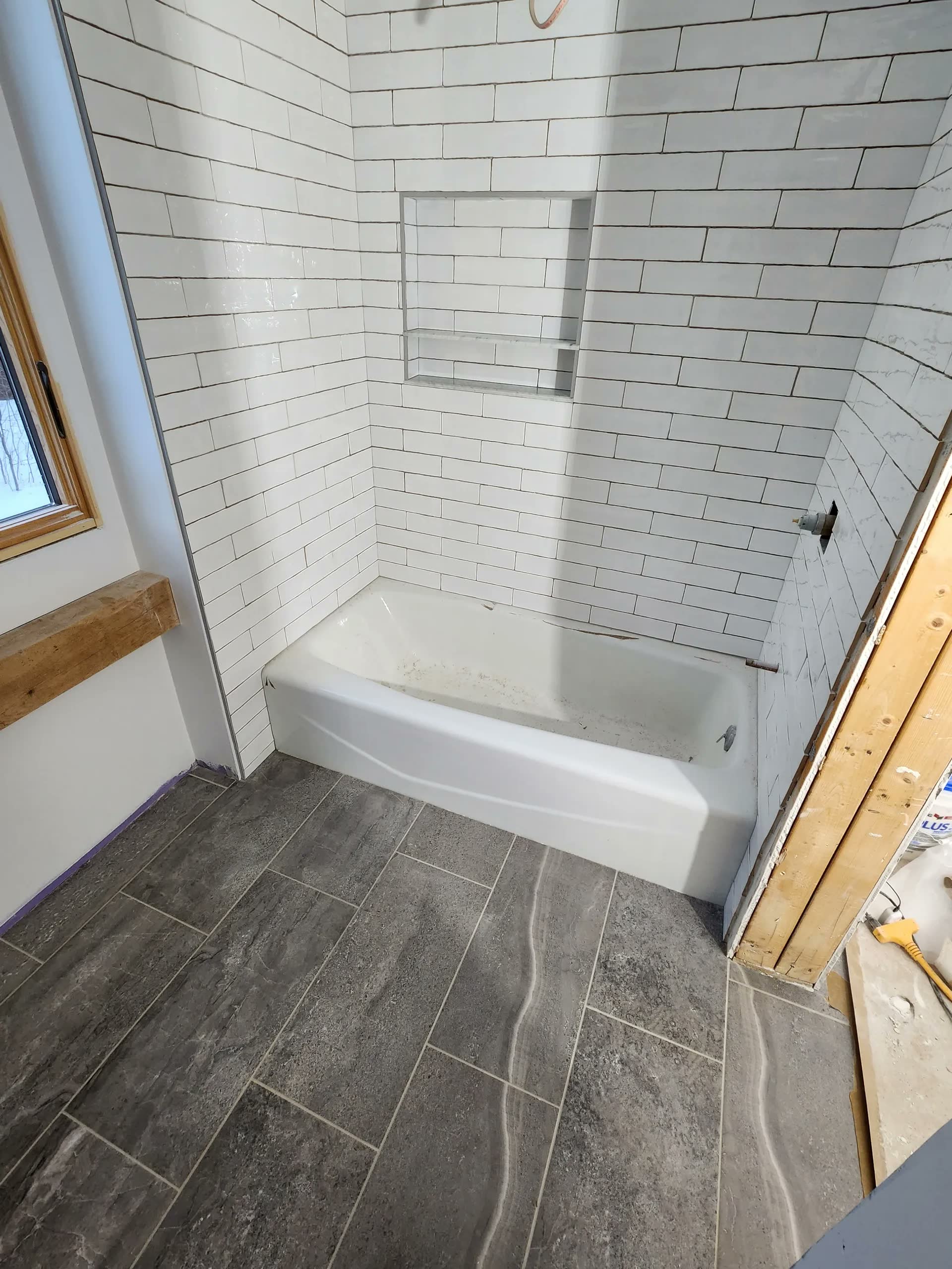 Wood look tile flooring winter construction bathroom remodel maine